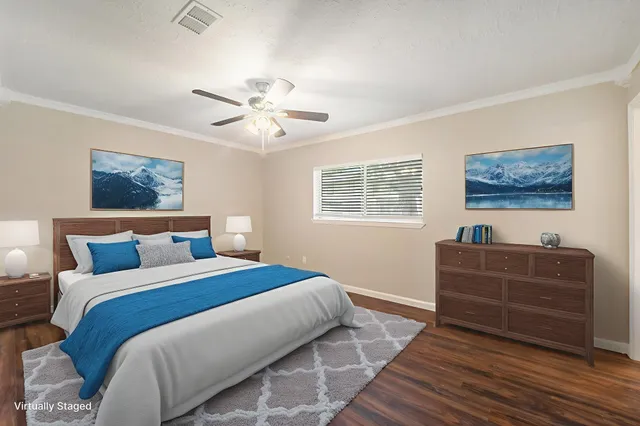 a bedroom with a bed lamp and furniture