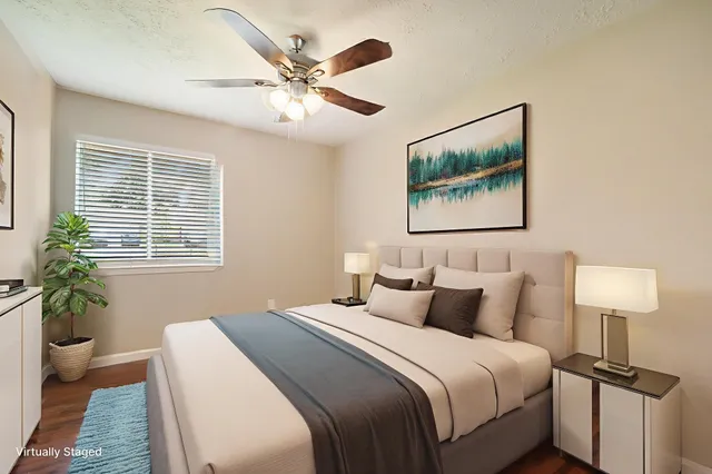 a bedroom with a large bed and a lamp