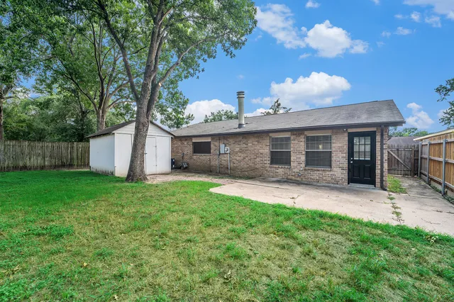 a front view of a house with a garden and yard