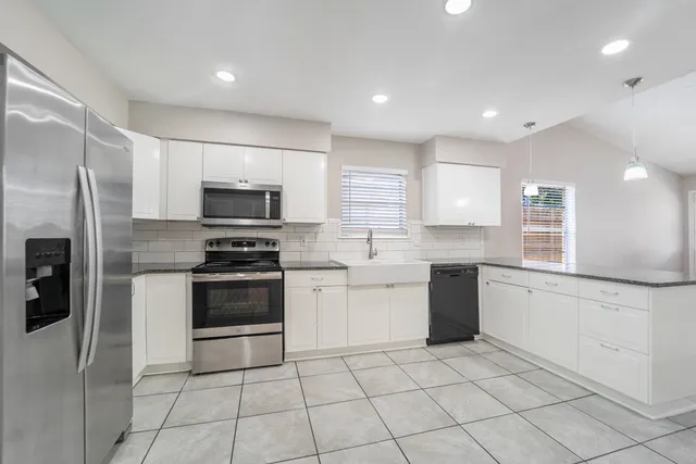 a kitchen with a sink stainless steel appliances and cabinets