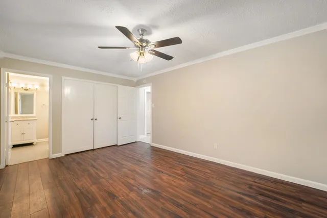 a view of a big room with wooden floor and closet area