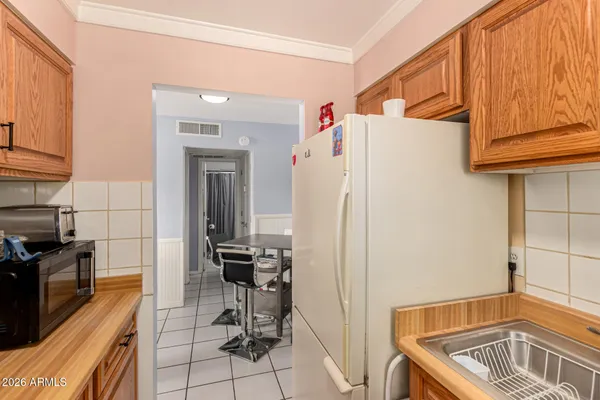 a kitchen with refrigerator and cabinets