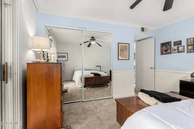 a bedroom with a bed and a couch