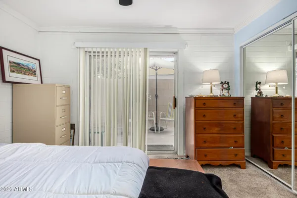 a bedroom with a bed and a dresser