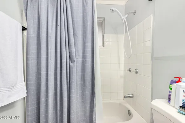 a bathroom with a tub and shower