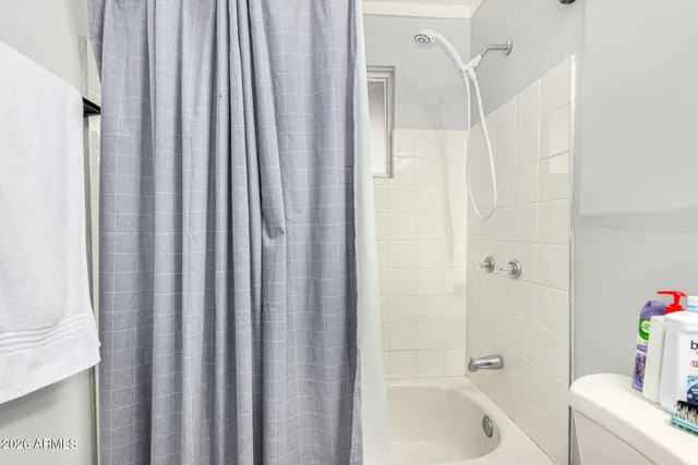 a bathroom with a tub and shower