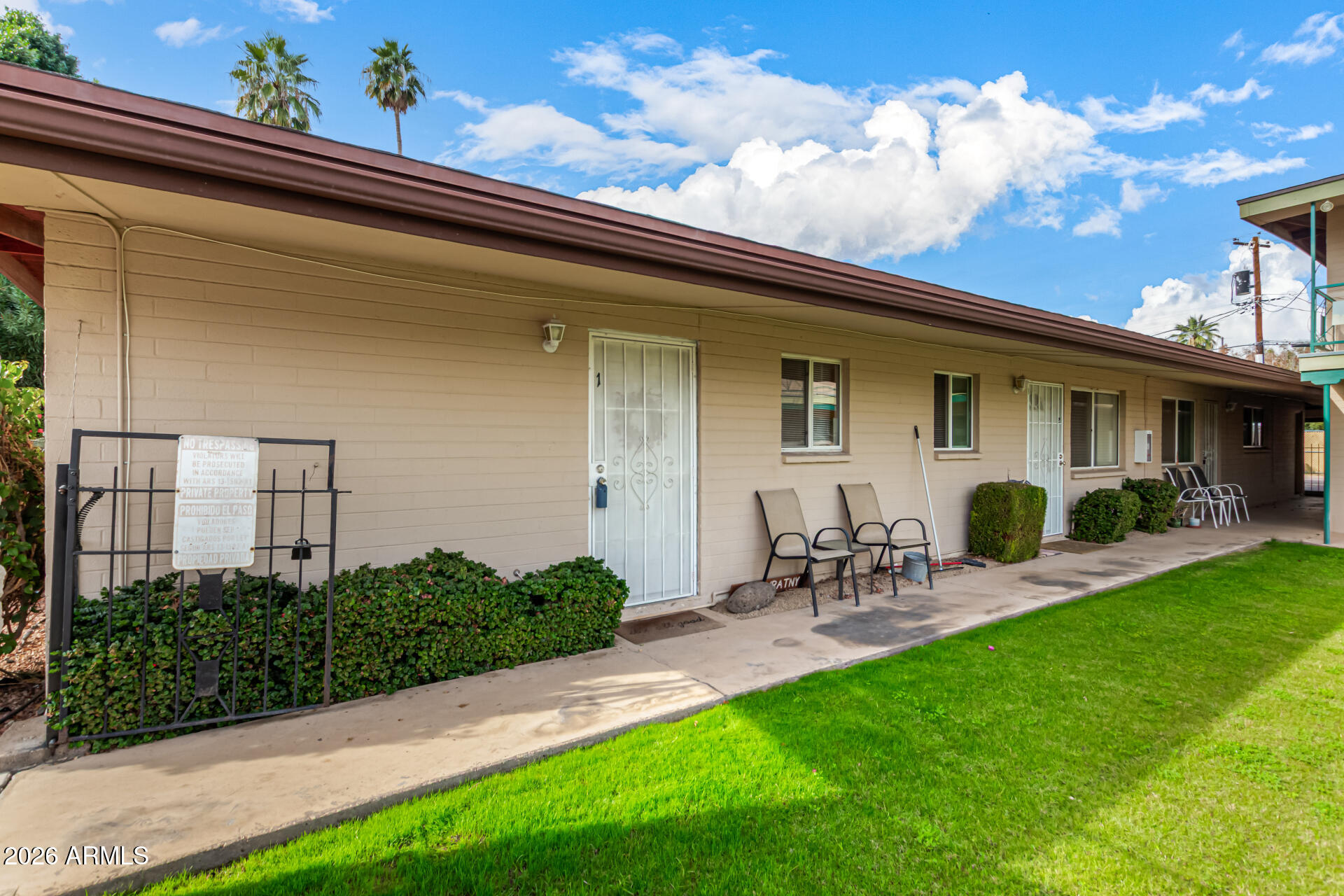 1908 West Berridge Lane, Unit 1 Phoenix, AZ 85015 - Photo 2 of 29 a view of a patio with table and chairs potted plants and a large tree