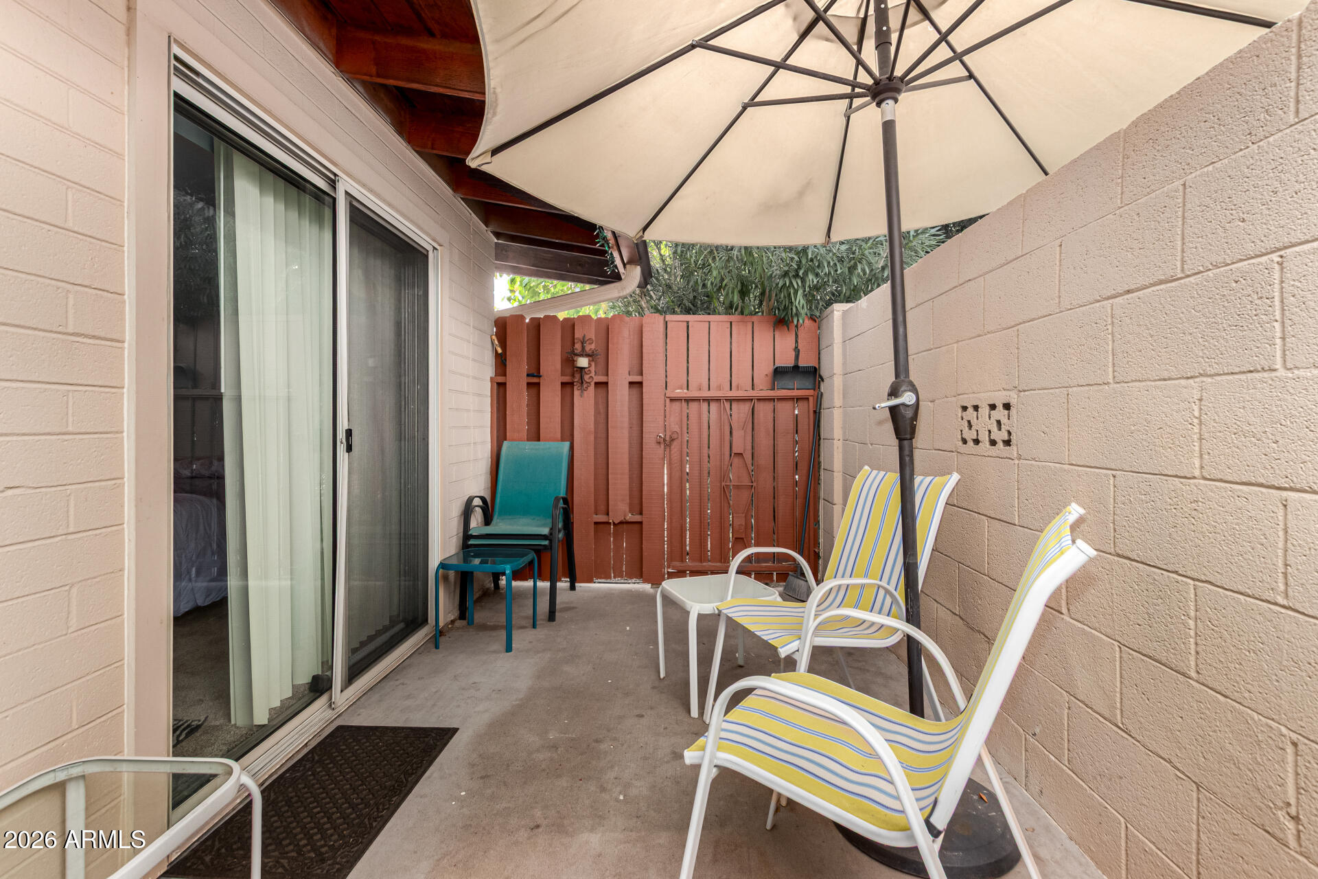 1908 West Berridge Lane, Unit 1 Phoenix, AZ 85015 - Photo 22 of 29 a view of a patio with table and chairs under an umbrella