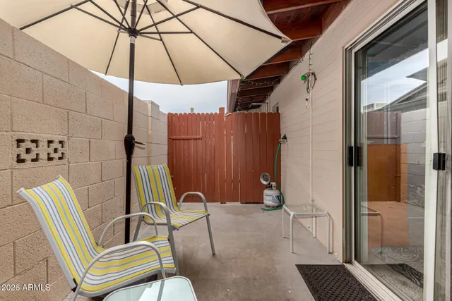 a patio with a table and chairs