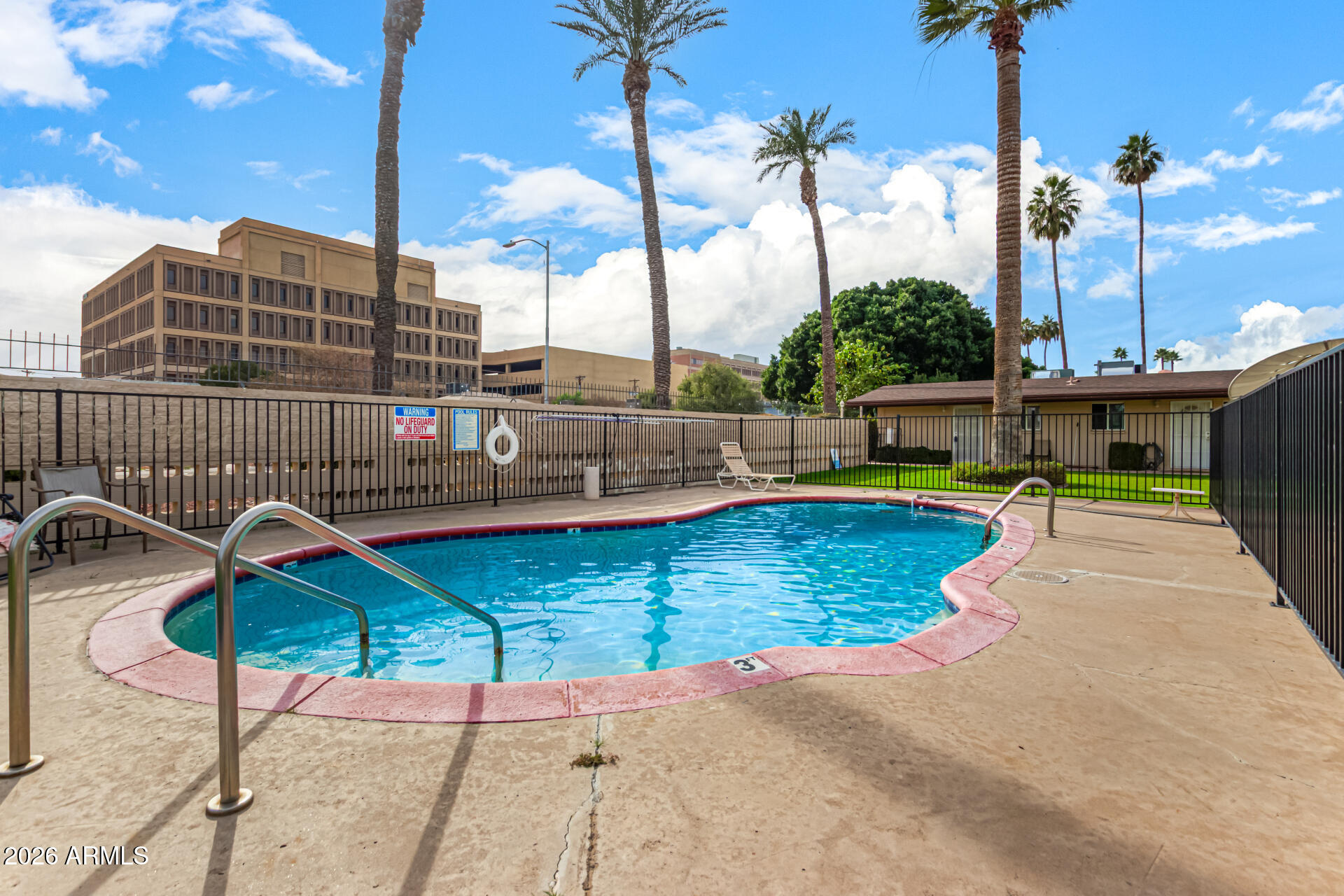 1908 West Berridge Lane, Unit 1 Phoenix, AZ 85015 - Photo 27 of 29 a view of a swimming pool with a lounge chairs