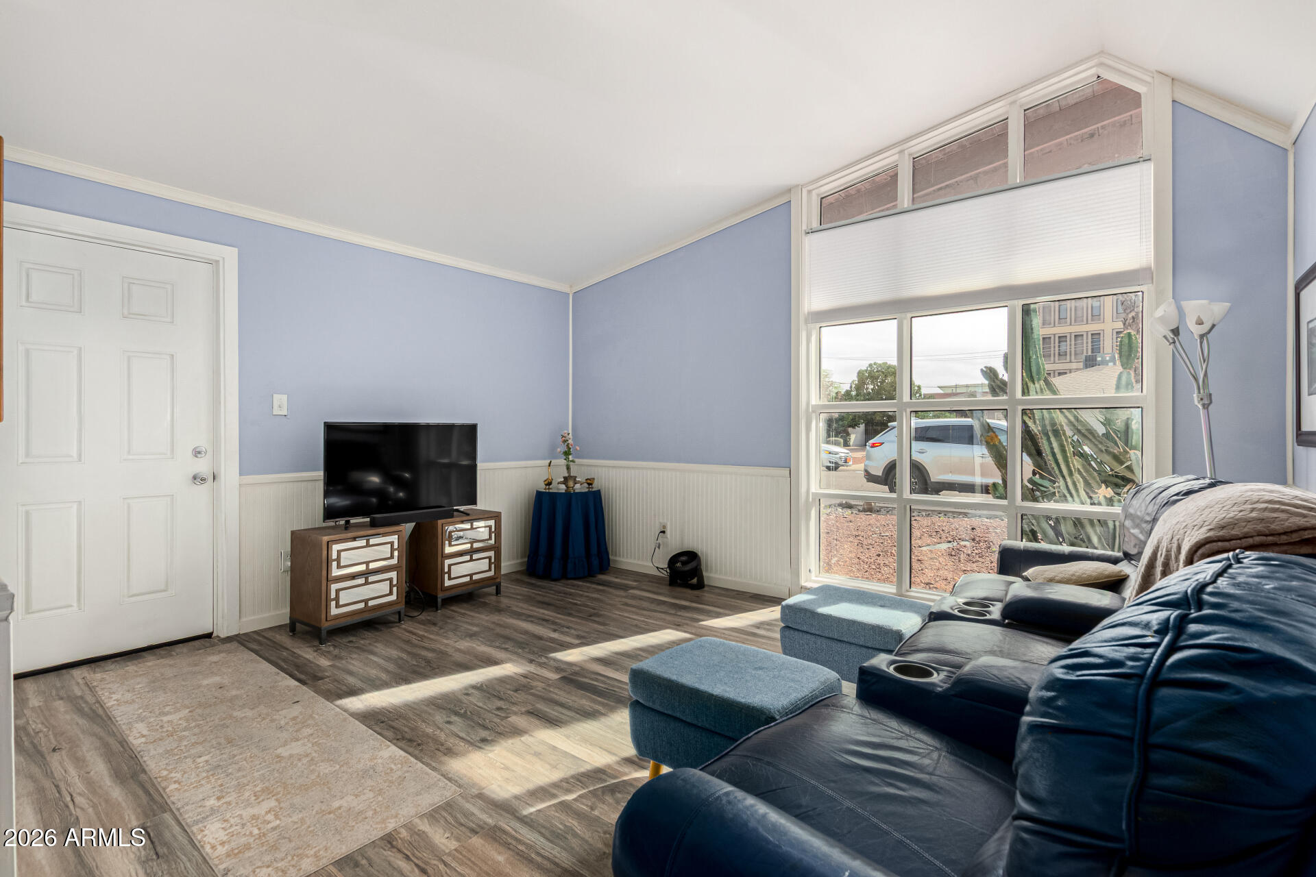 1908 West Berridge Lane, Unit 1 Phoenix, AZ 85015 - Photo 5 of 29 a living room with furniture a flat screen tv and a large window