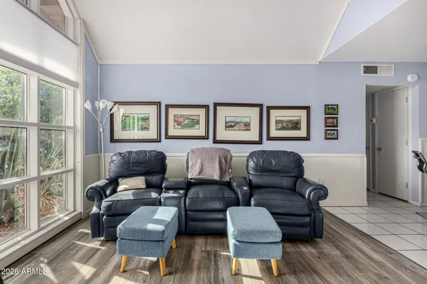 a spacious bedroom with furniture and a window