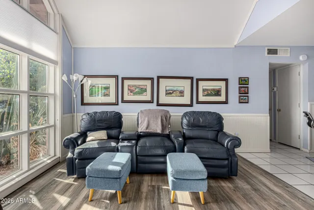 a spacious bedroom with furniture and a window