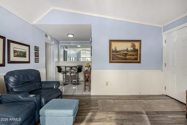 a living room with furniture and wooden floor