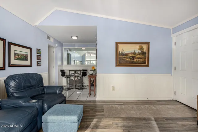 a living room with furniture and wooden floor