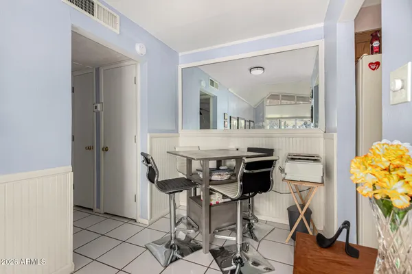 a kitchen with stainless steel appliances a dining table chairs and chandelier