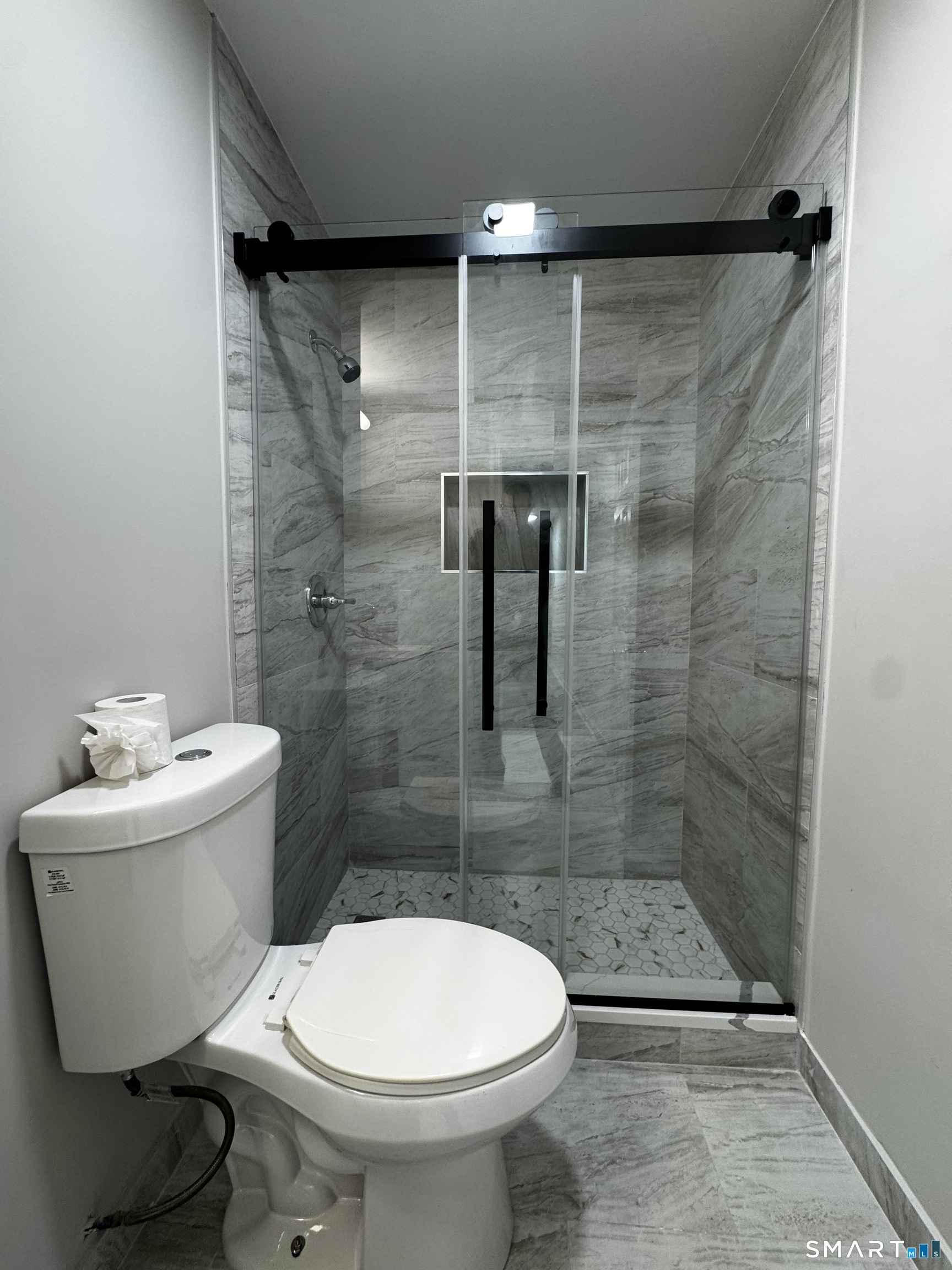 45-51 Cowles Street, Unit 45 Bridgeport, CT 06607 - Photo 14 of 33 completely renovated bathroom with new vanity, new medicine cabinet, new standup shower with frameless sliding glass door, new tile floor, new lighting and paint