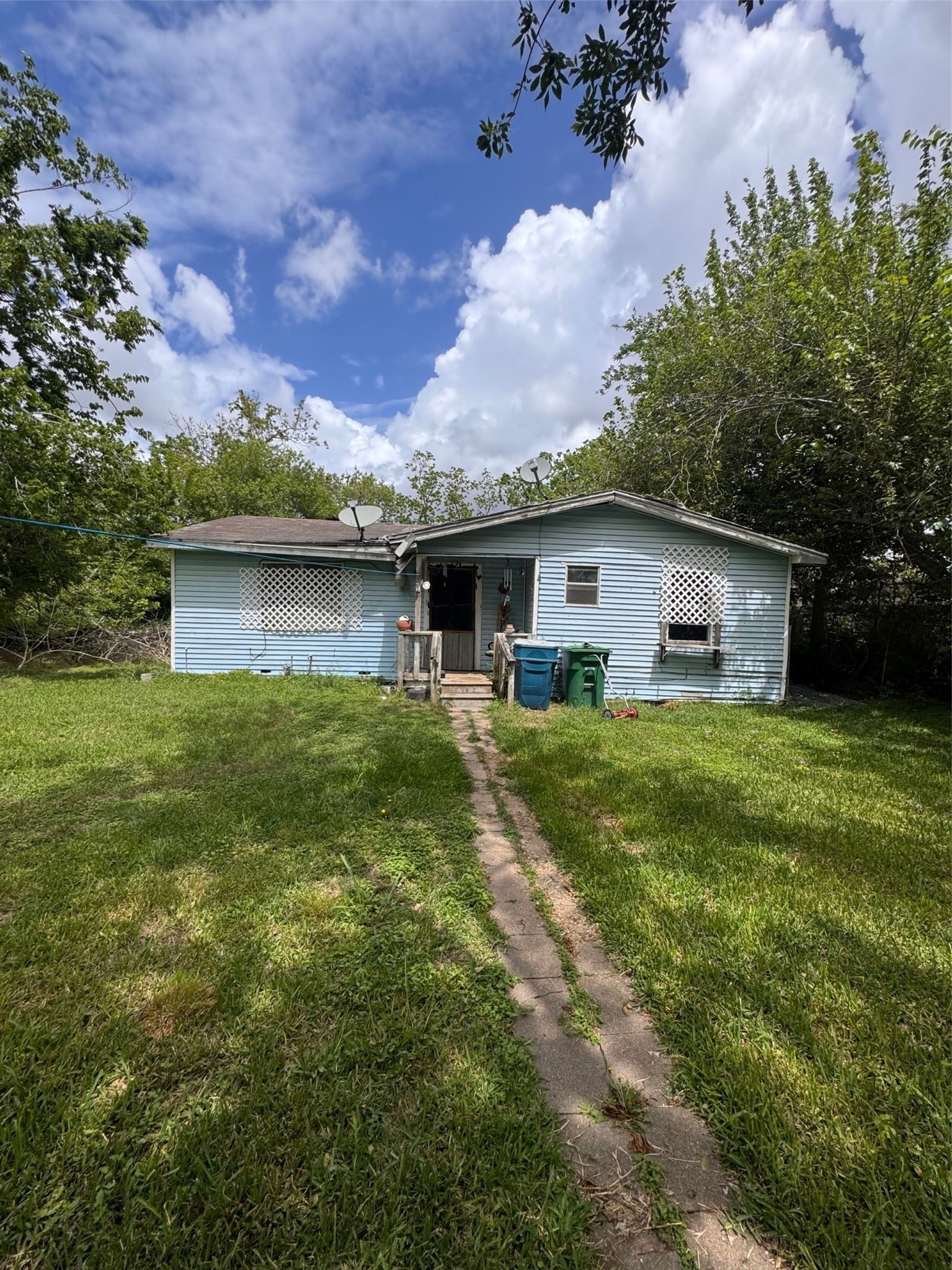 a front view of house with yard and green space