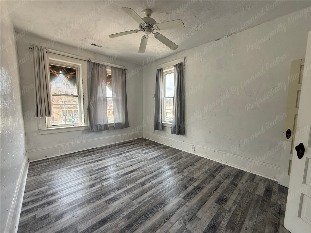 44 West High Street, Unit D Springfield, OH 45502 - Photo 9 of 25 This bright room features durable flooring and ample natural light, creating a comfortable living space.