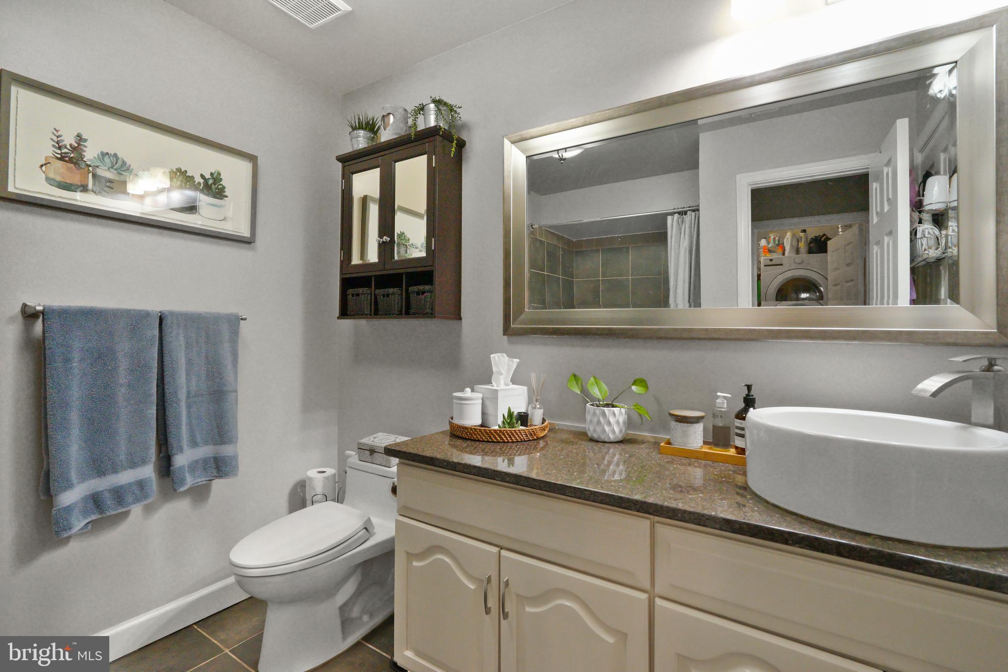 1435 Church Hill Place Reston, VA 20194 - Photo 12 of 30 a bathroom with a toilet a sink and mirror