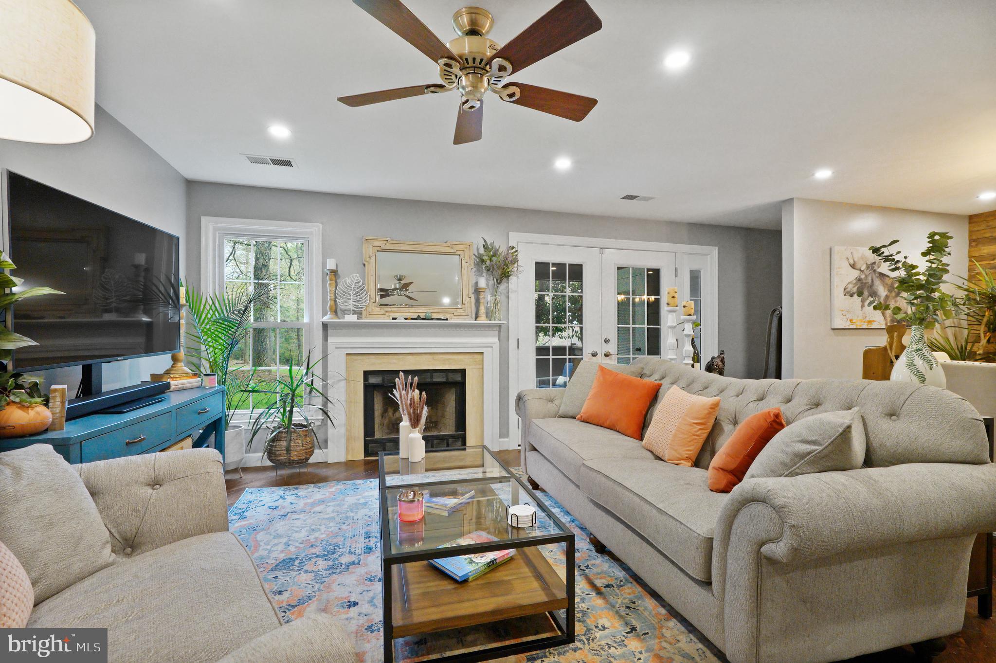 1435 Church Hill Place Reston, VA 20194 - Photo 4 of 30 a living room with furniture a flat screen tv and a fireplace