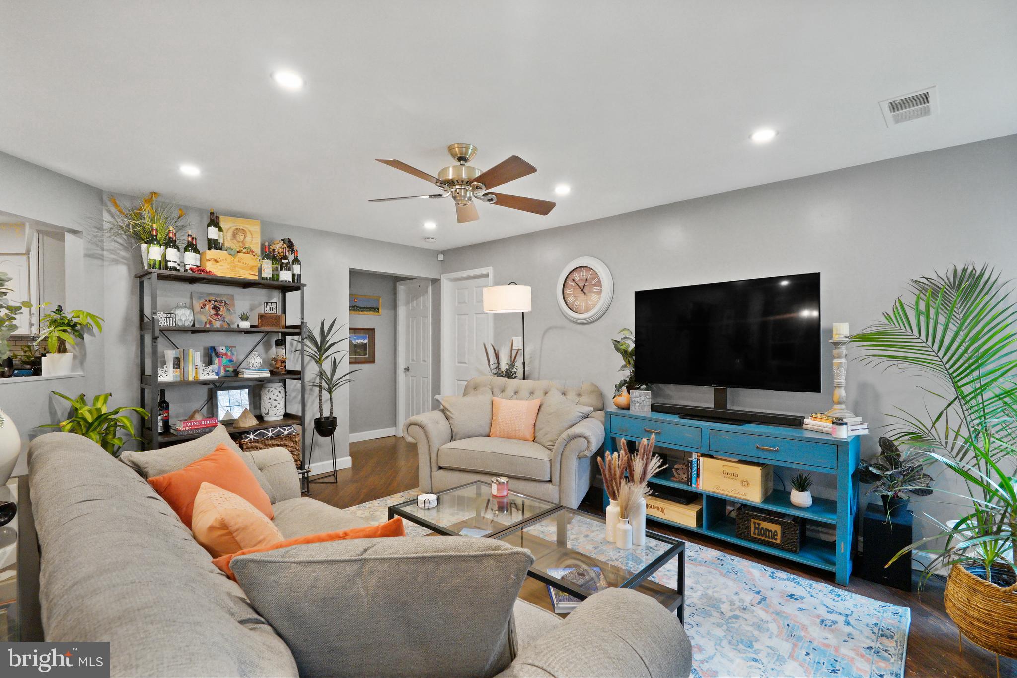 1435 Church Hill Place Reston, VA 20194 - Photo 5 of 30 a living room with furniture and a flat screen tv
