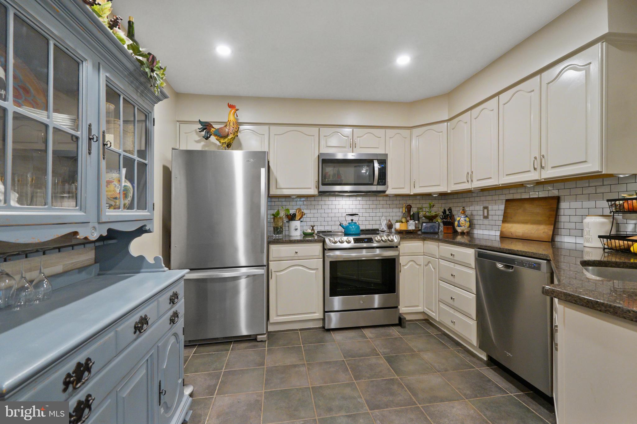 1435 Church Hill Place Reston, VA 20194 - Photo 8 of 30 a kitchen with stainless steel appliances granite countertop a refrigerator stove microwave and sink