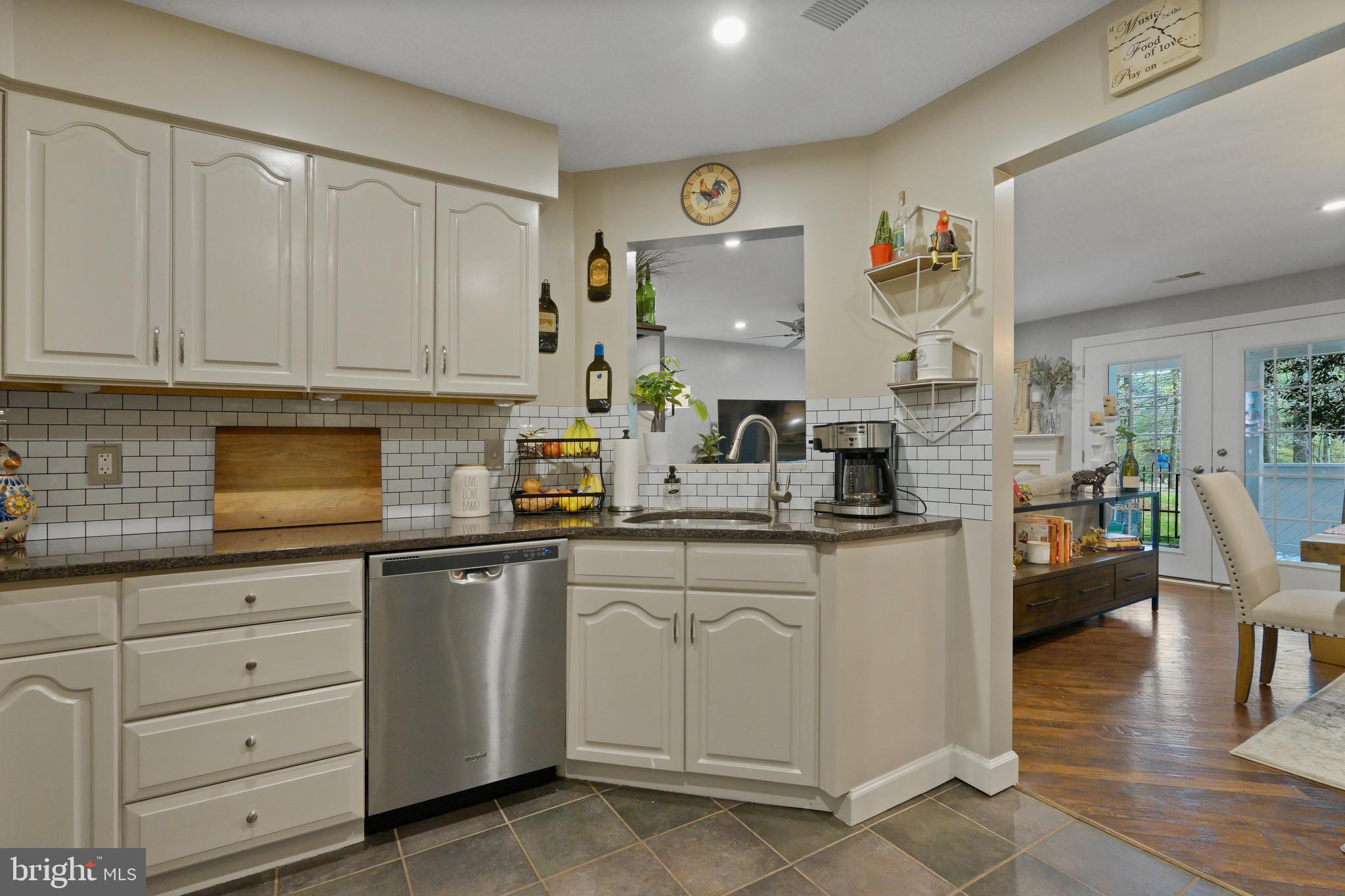1435 Church Hill Place Reston, VA 20194 - Photo 9 of 30 a kitchen with white cabinets and sink