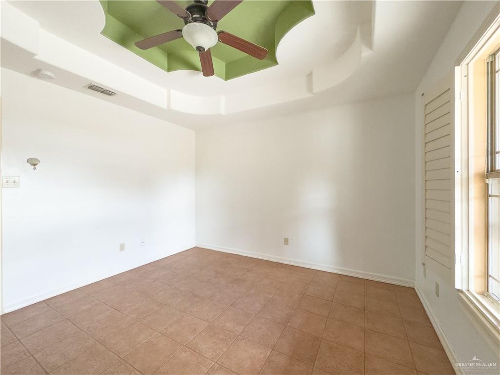 3909 Tulipan Street Mission, TX 78573 - Photo 13 of 18 an empty room with a window and a fan