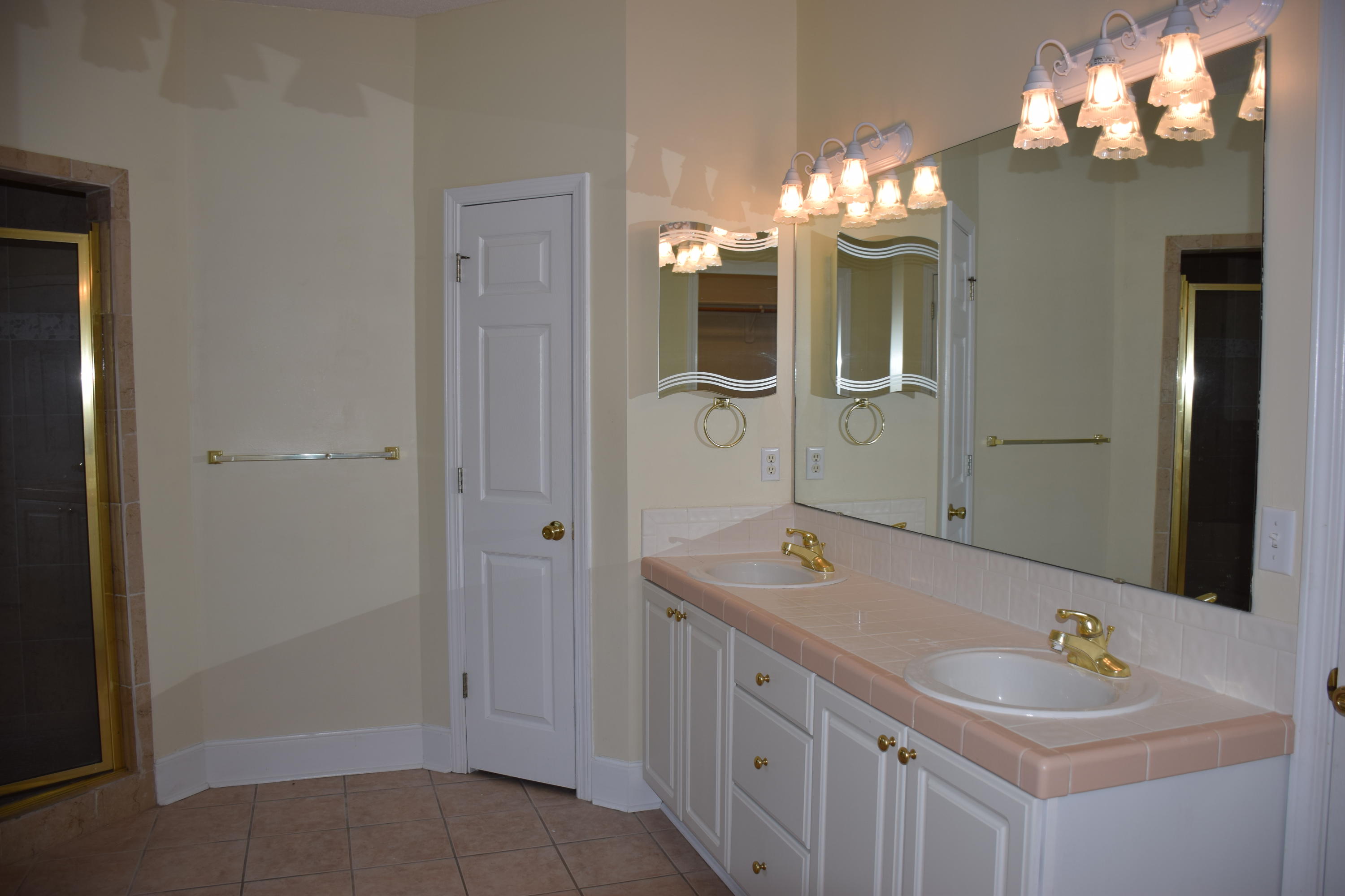 1828 Huntington Road Niceville, FL 32578 - Photo 16 of 27 a bathroom with a double vanity sink mirror and shower