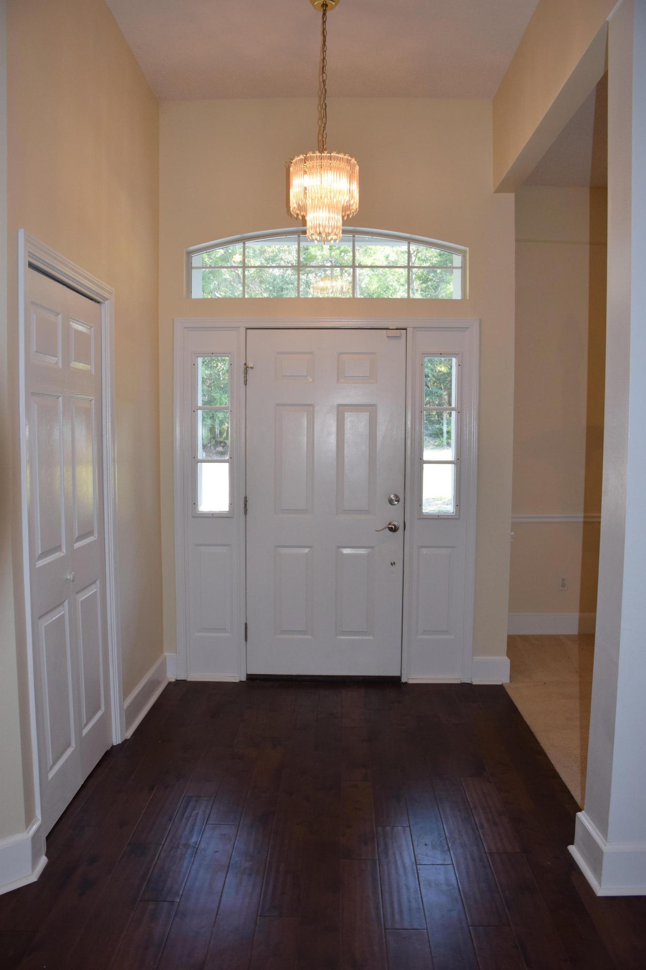 1828 Huntington Road Niceville, FL 32578 - Photo 3 of 27 an empty room with wooden floor and windows
