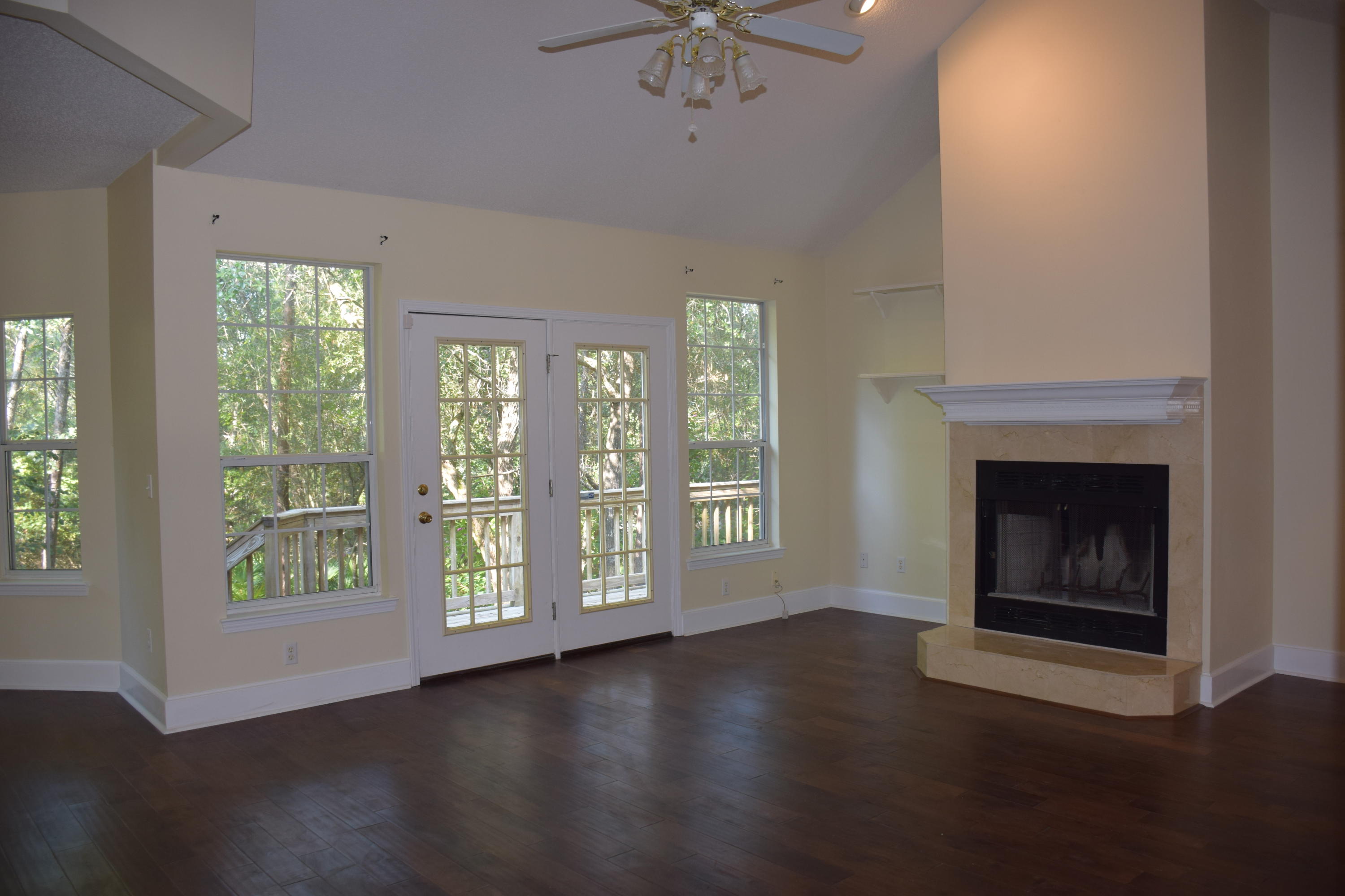 1828 Huntington Road Niceville, FL 32578 - Photo 5 of 27 a view of an empty room with a window and wooden floor