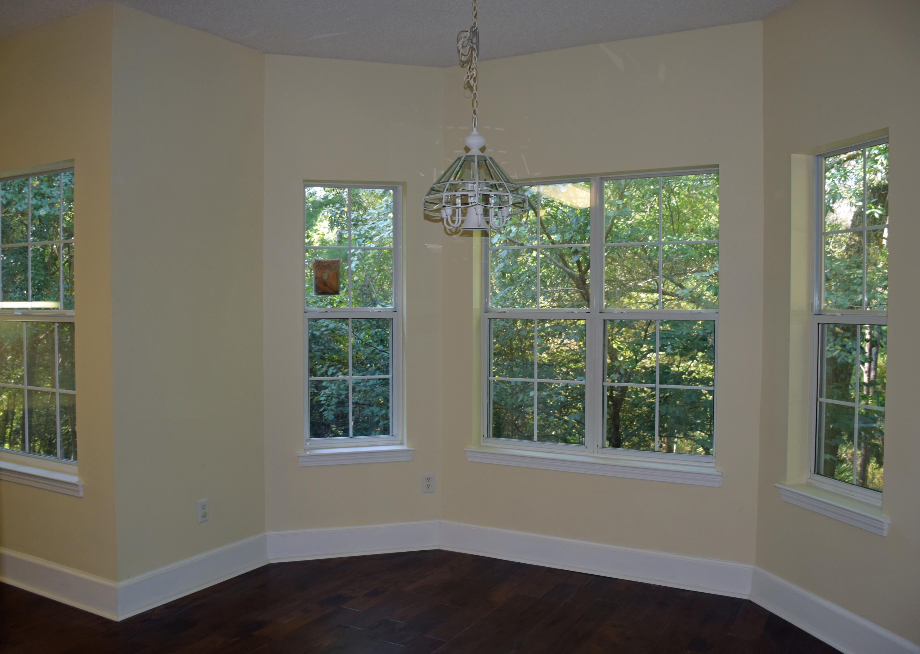 1828 Huntington Road Niceville, FL 32578 - Photo 6 of 27 a dining room with wooden floor a chandelier and windows