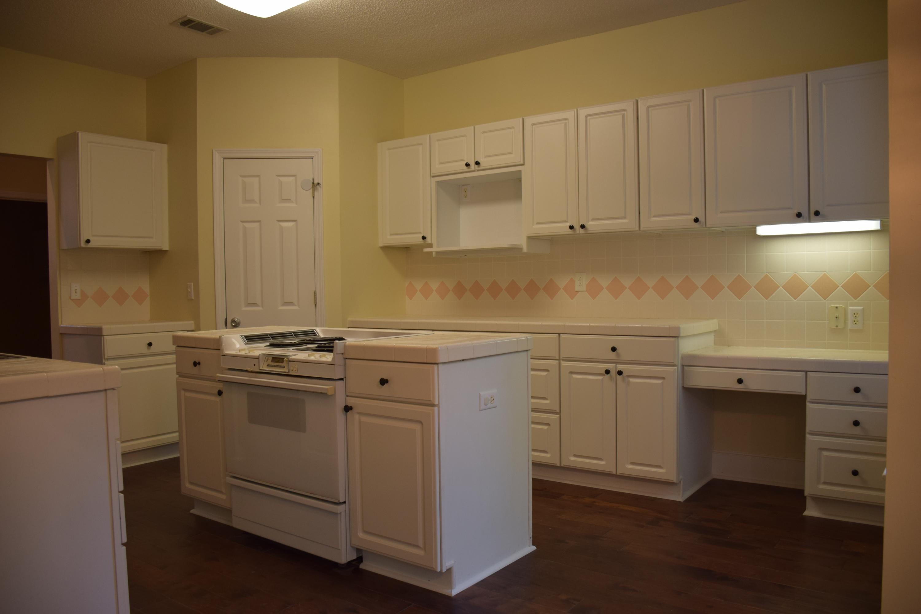 1828 Huntington Road Niceville, FL 32578 - Photo 7 of 27 a kitchen with stainless steel appliances granite countertop a sink stove and cabinets