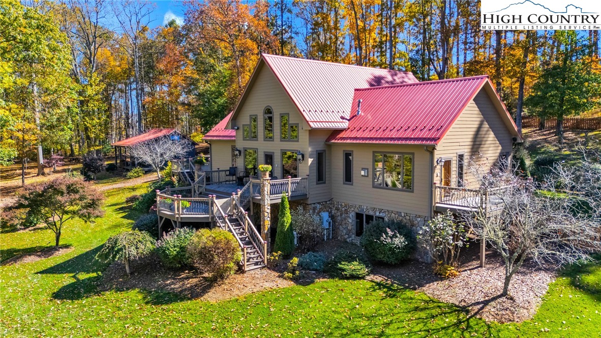 2650 Carson Woods Road Laurel Springs, NC 28644 - Photo 1 of 50 a view of a house with a yard patio and fire pit