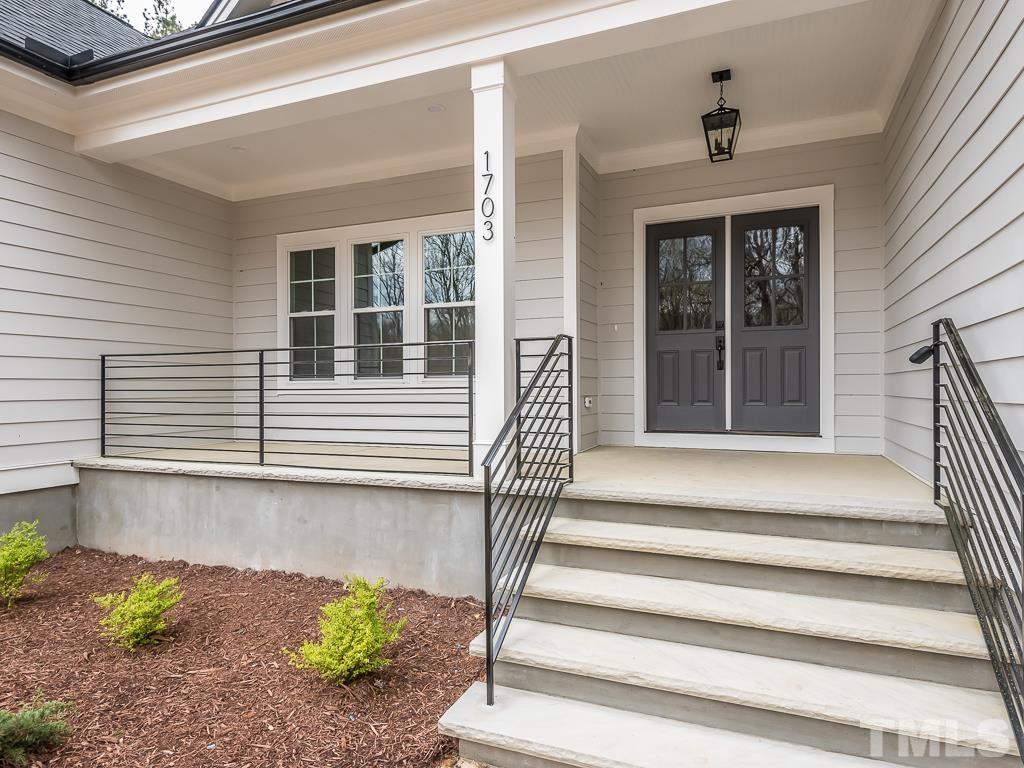 1703 Milton Road Durham, NC 27712 - Photo 4 of 39 a view of a house with a window and wooden bench