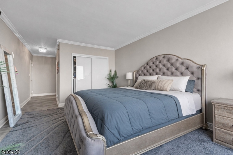 6 Horizon Road, Unit 2809 Fort Lee, NJ 07024 - Photo 12 of 19 a bedroom with a bed and wooden floor