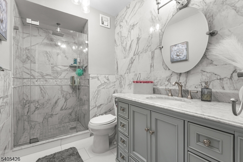 6 Horizon Road, Unit 2809 Fort Lee, NJ 07024 - Photo 13 of 19 a bathroom with a granite countertop sink mirror and toilet