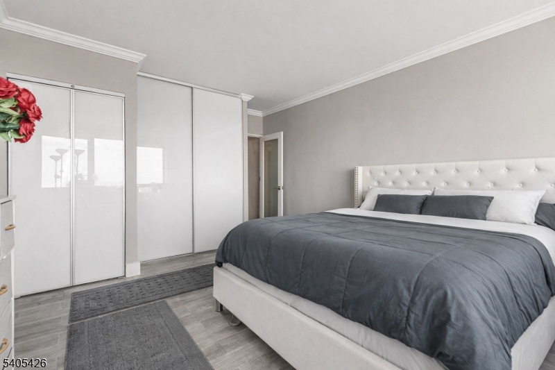 6 Horizon Road, Unit 2809 Fort Lee, NJ 07024 - Photo 14 of 19 a bedroom with a bed and a window