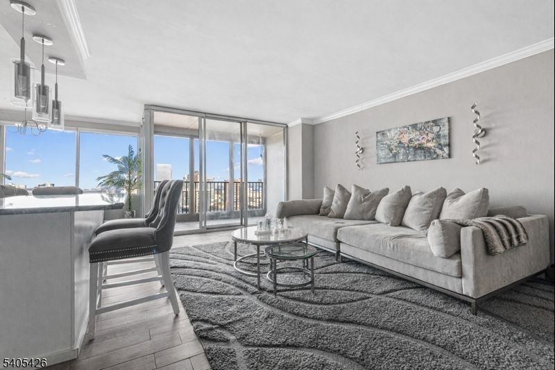 6 Horizon Road, Unit 2809 Fort Lee, NJ 07024 - Photo 2 of 19 a living room with furniture and a large window
