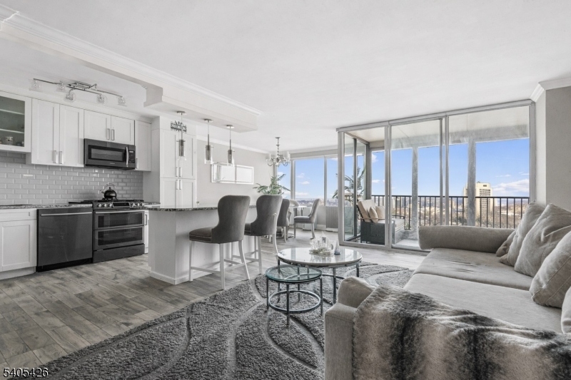 6 Horizon Road, Unit 2809 Fort Lee, NJ 07024 - Photo 3 of 19 a living room with furniture a rug kitchen view and a window