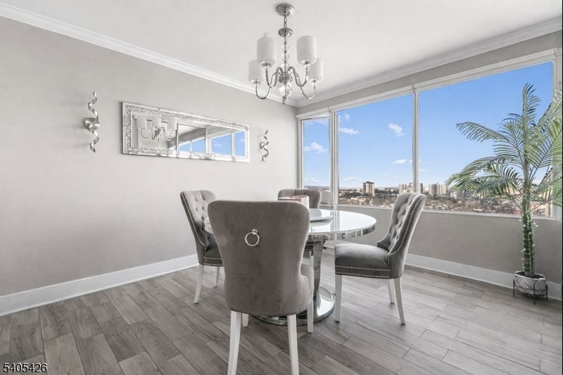 6 Horizon Road, Unit 2809 Fort Lee, NJ 07024 - Photo 5 of 19 a dining room with furniture a chandelier and wooden floor