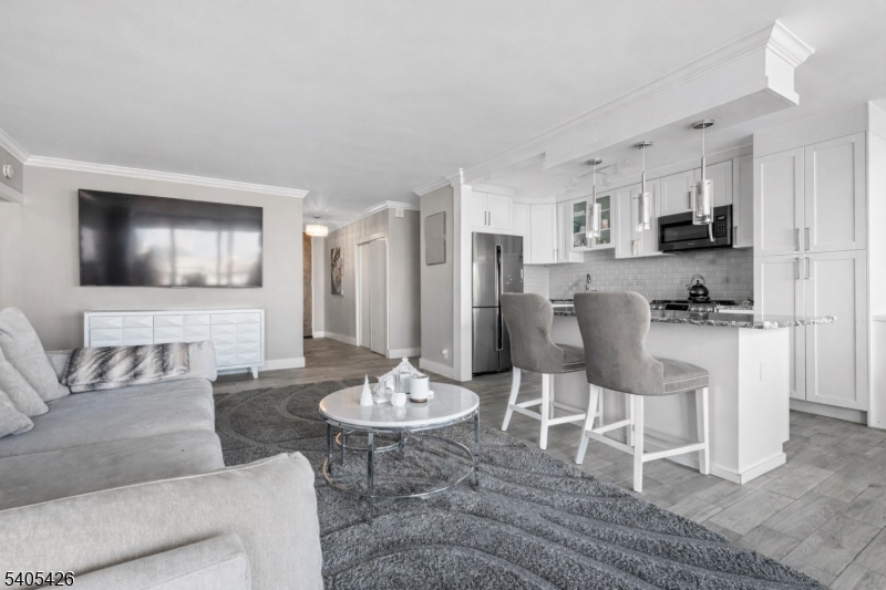 6 Horizon Road, Unit 2809 Fort Lee, NJ 07024 - Photo 8 of 19 a dining room with furniture kitchen view and a wooden floor