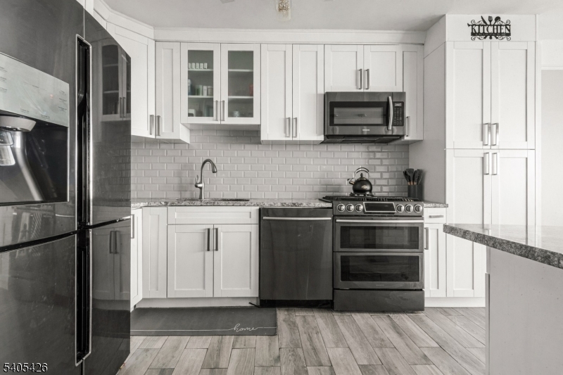 6 Horizon Road, Unit 2809 Fort Lee, NJ 07024 - Photo 10 of 19 a kitchen with stainless steel appliances a refrigerator stove and microwave