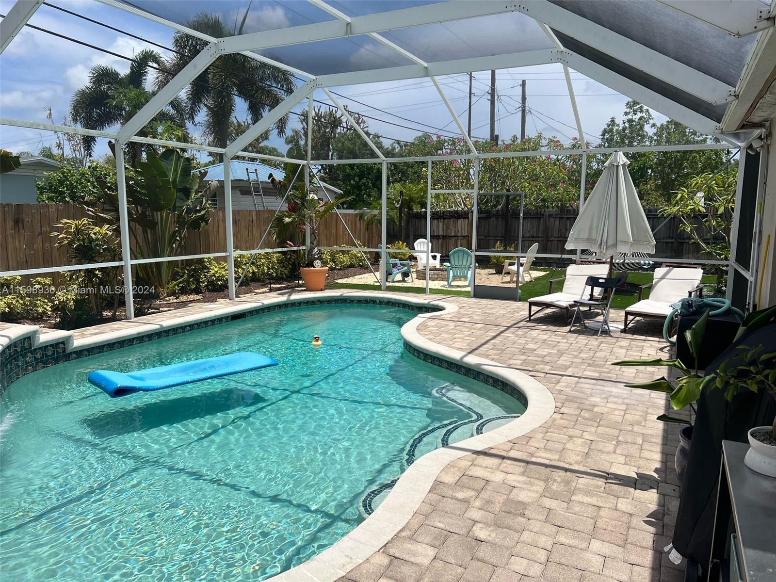 3121 Riverland Road Fort Lauderdale, FL 33312 - Photo 3 of 7 a view of a house with backyard sitting area and garden