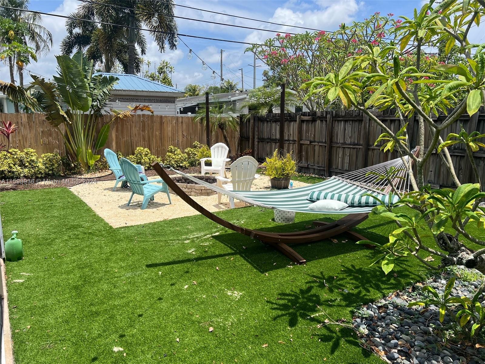 3121 Riverland Road Fort Lauderdale, FL 33312 - Photo 4 of 7 a view of a backyard with table and chairs potted plants and palm tree