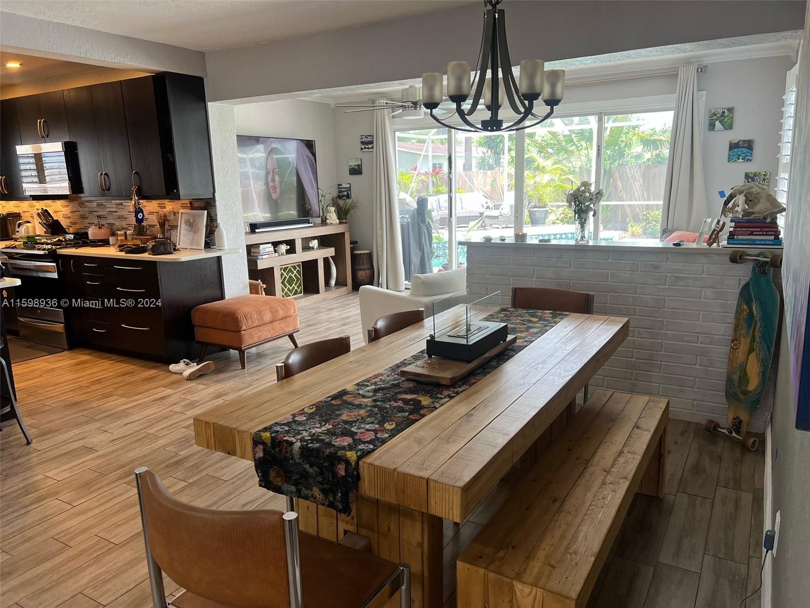 3121 Riverland Road Fort Lauderdale, FL 33312 - Photo 6 of 7 a living room with furniture dining table and a large window