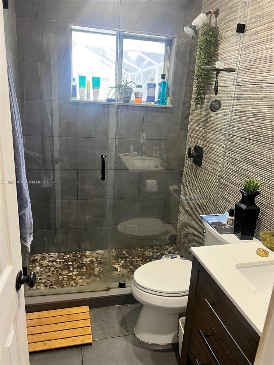 3121 Riverland Road Fort Lauderdale, FL 33312 - Photo 7 of 7 a bathroom with a sink a toilet and shower