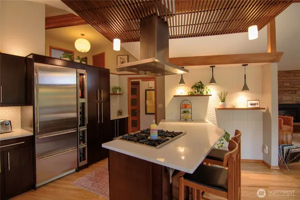 a kitchen with stainless steel appliances kitchen island granite countertop a sink and cabinets