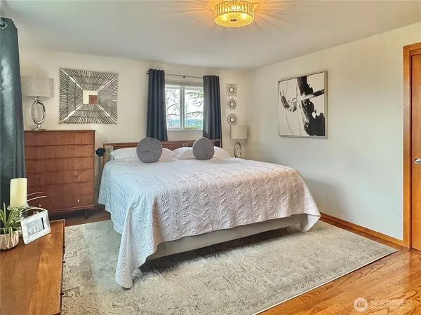 a bedroom with a bed and window